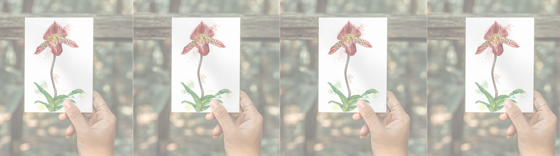 Hand holding a small watercolor orchid print, repeated across the image.