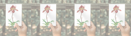 Hand holding a small watercolor orchid print, repeated across the image.